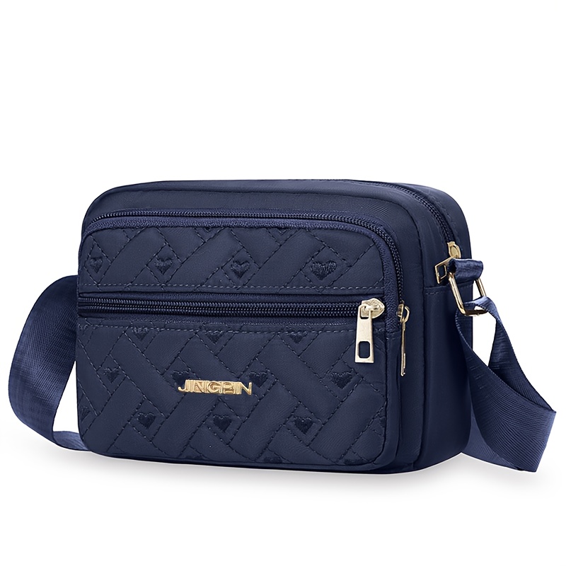 Borsa a tracolla da donna - Una borsa neutra a forma di…